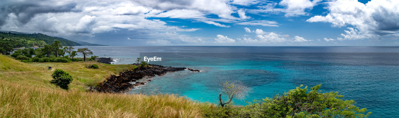 Panoramic view of sea against cloudy sky