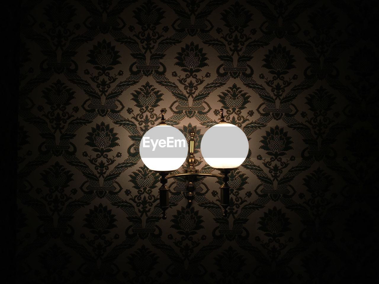 Close-up of lit wall lamp