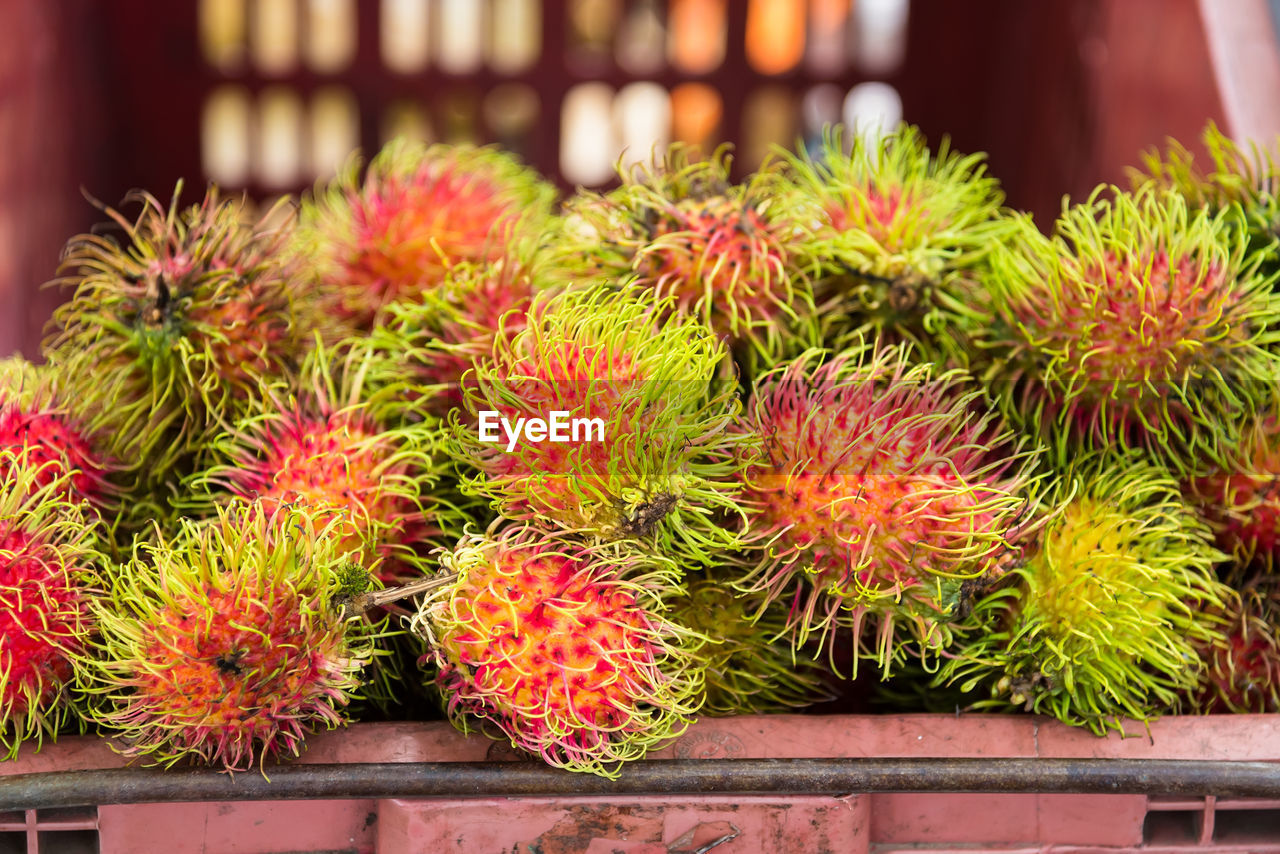 Close-up of rambutans for sale at market stall