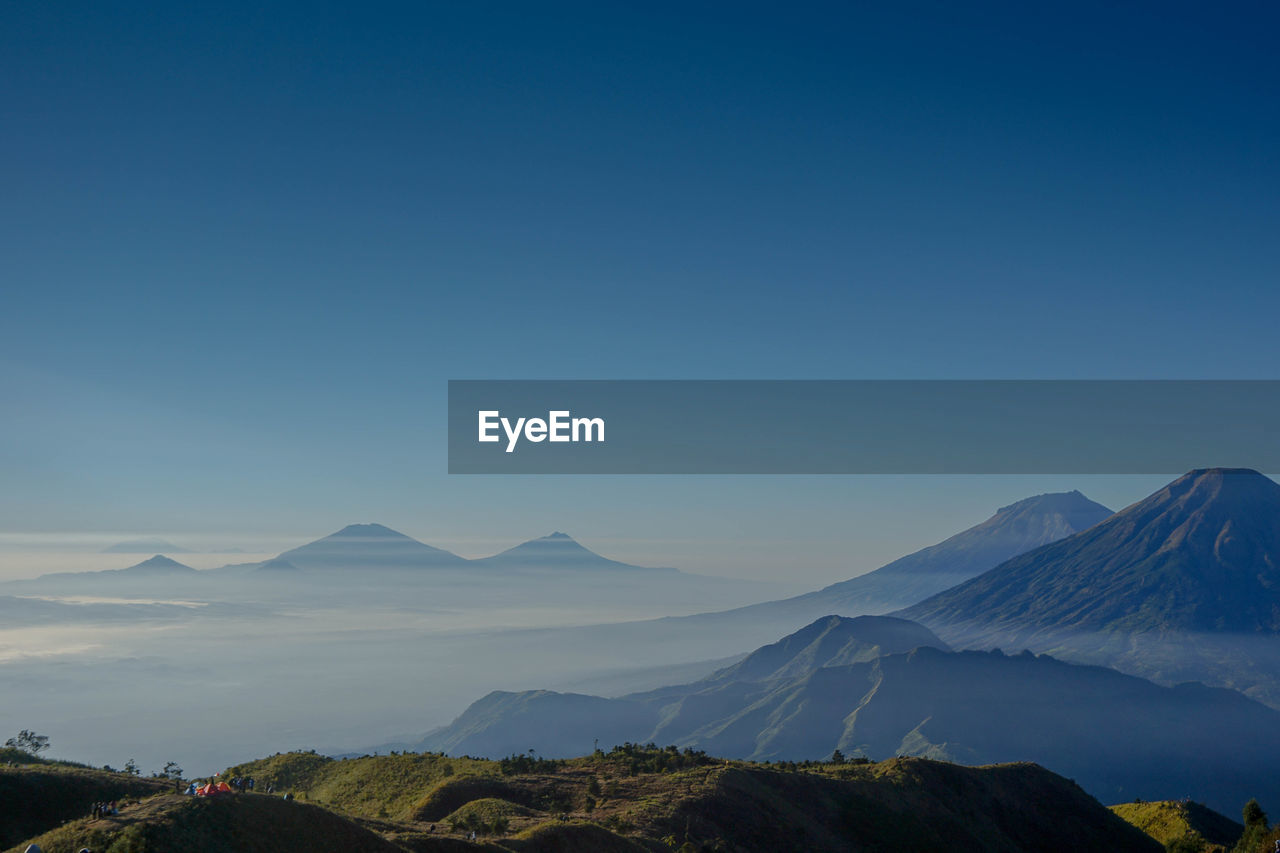 SCENIC VIEW OF MOUNTAINS AGAINST BLUE SKY