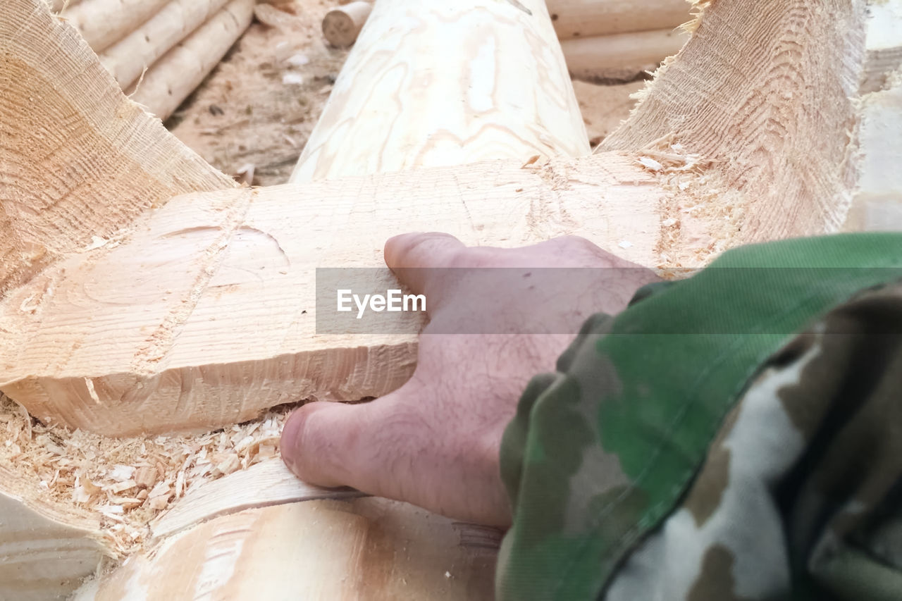 LOW SECTION OF MAN WORKING ON WOODEN FLOOR