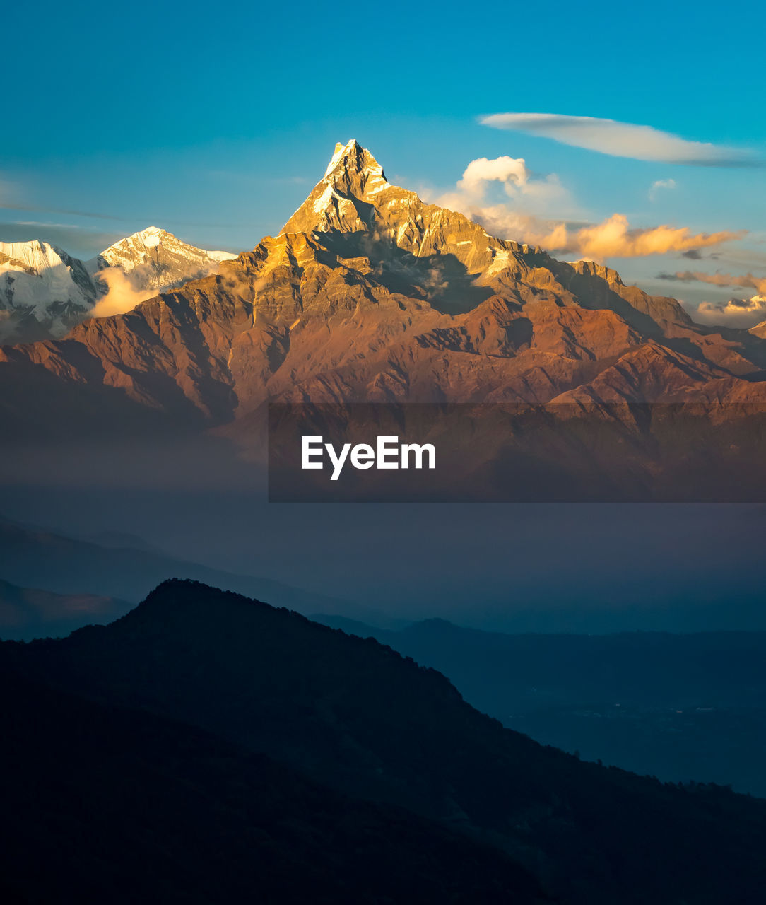 Scenic view of mountain range against blue sky