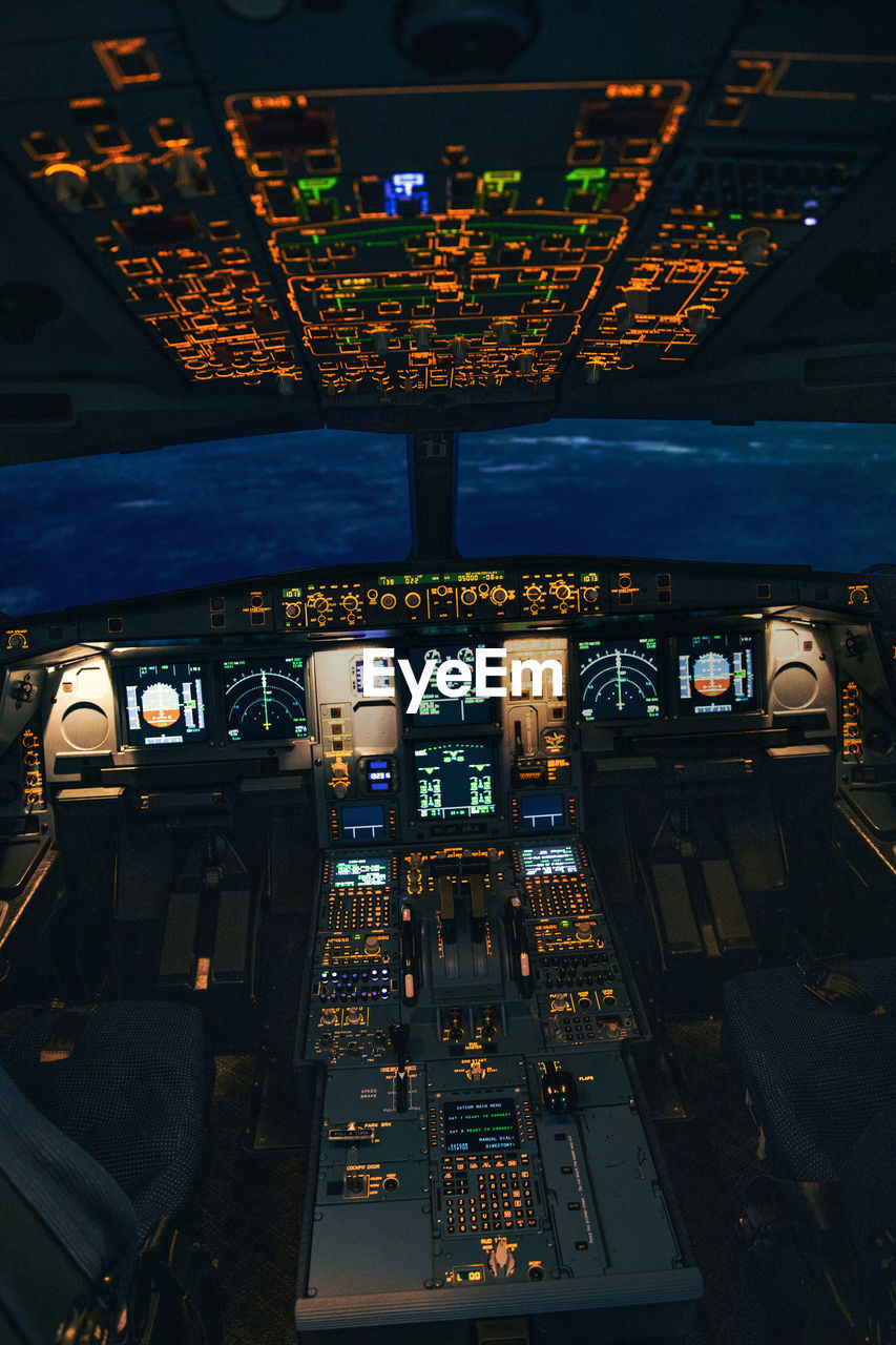 AERIAL VIEW OF ILLUMINATED AIRPLANE SEEN THROUGH TRAIN