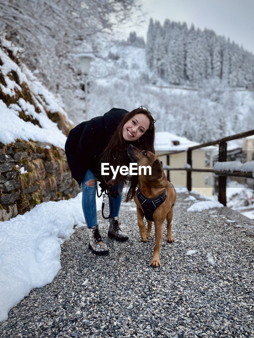 Woman with dog on snow