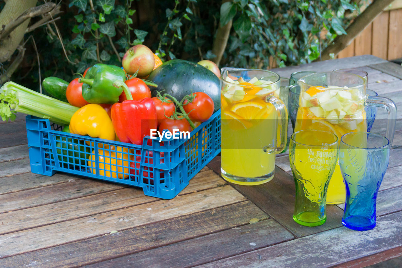 Close-up of drink in glass by vegetables on table