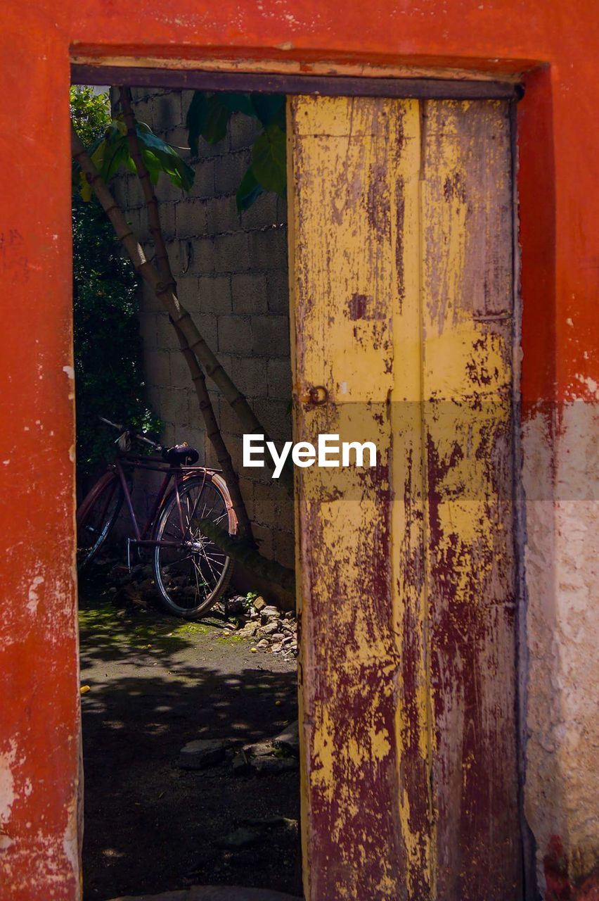 CLOSE-UP OF ABANDONED DOOR WITH HANDLE