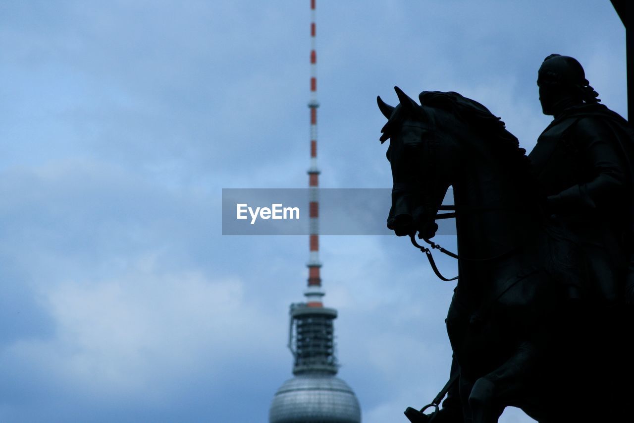 Low angle view of statue against cloudy sky