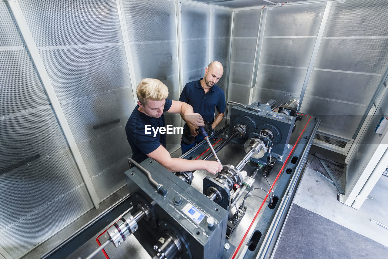 Two colleagues working in modern factory