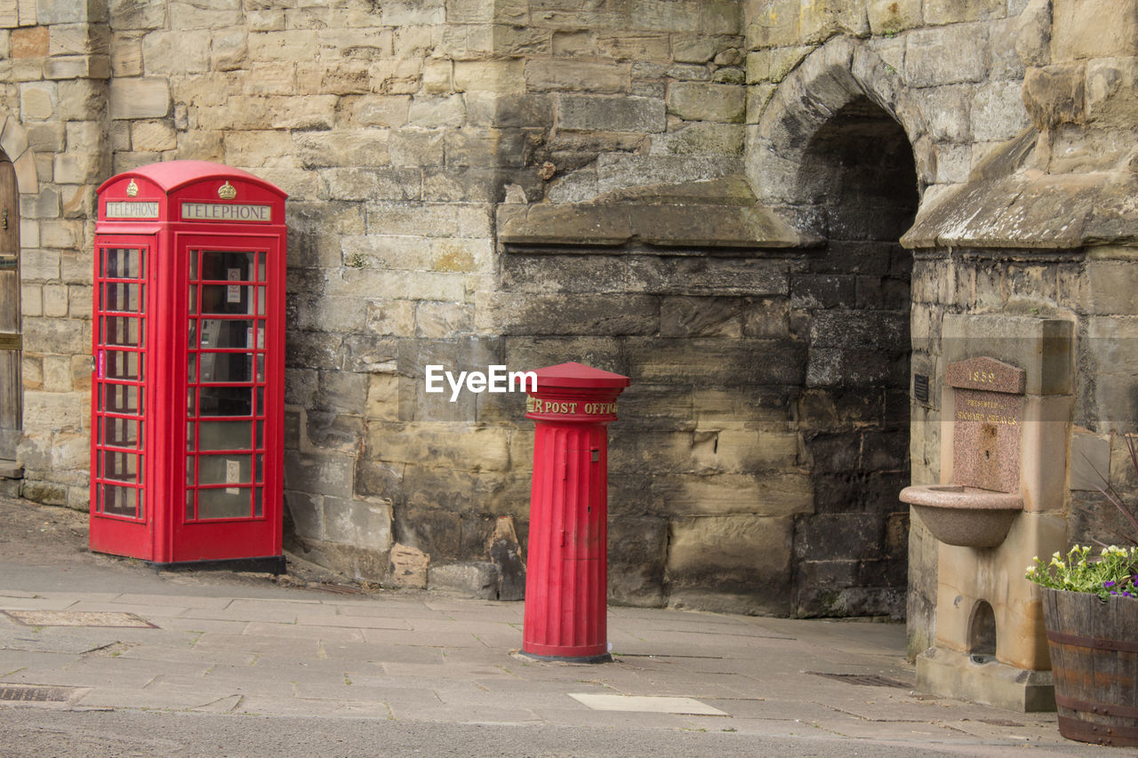 Telephone booth by wall