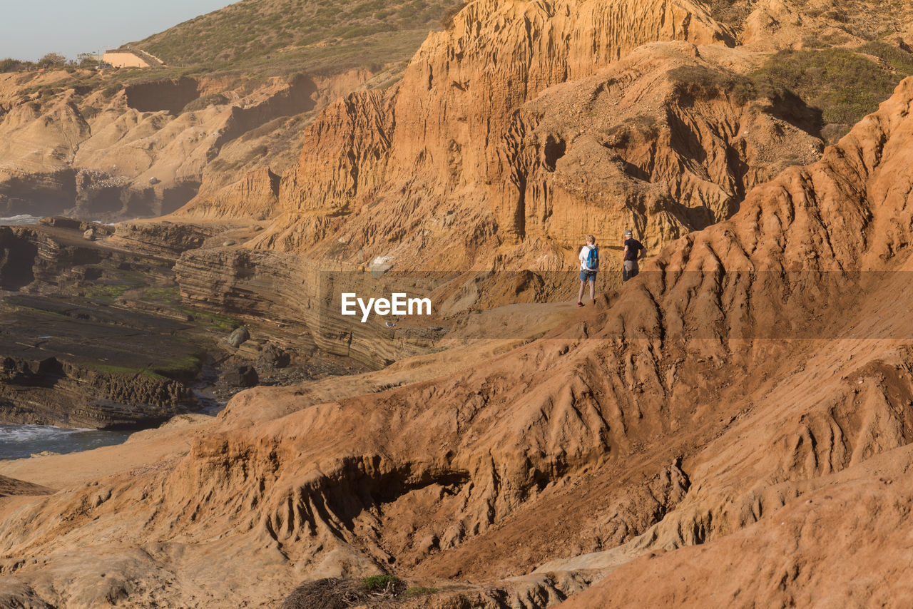 Hikers standing on rocky mountain