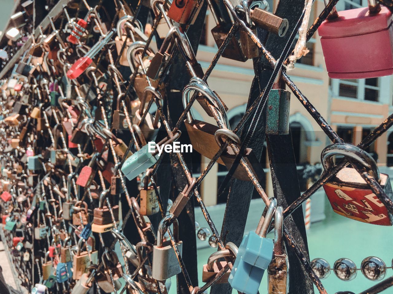 Close-up of padlocks hanging on fence