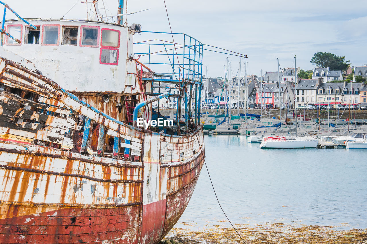 BOATS MOORED AT HARBOR