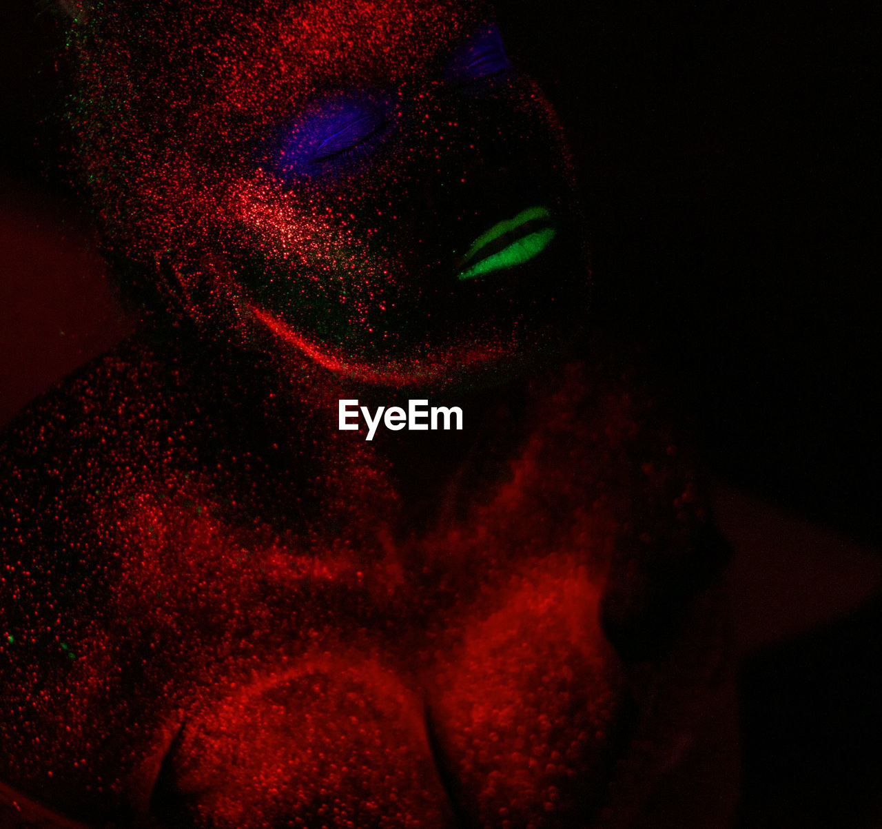 Woman with eyes closed in neon make-up