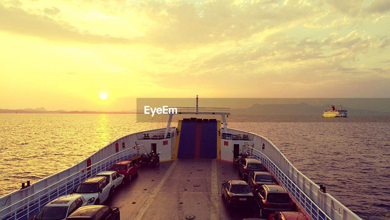 View of cars in ship on sea water at dusk