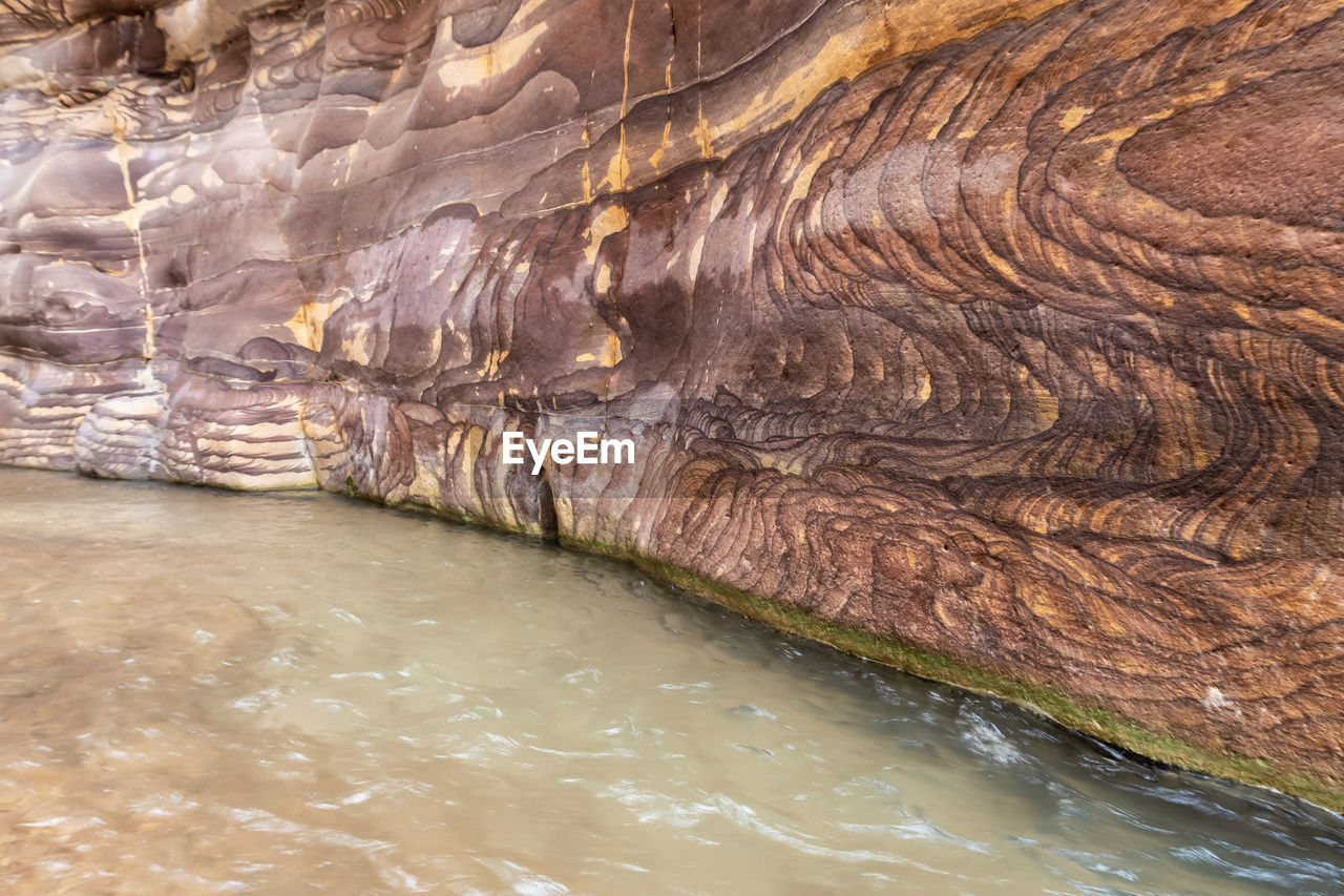 water, nature, rock, beauty in nature, no people, rock formation, geology, scenics - nature, day, non-urban scene, wadi, environment, outdoors, tranquility, river, travel destinations, formation, waterfront, land, cave, travel, tranquil scene