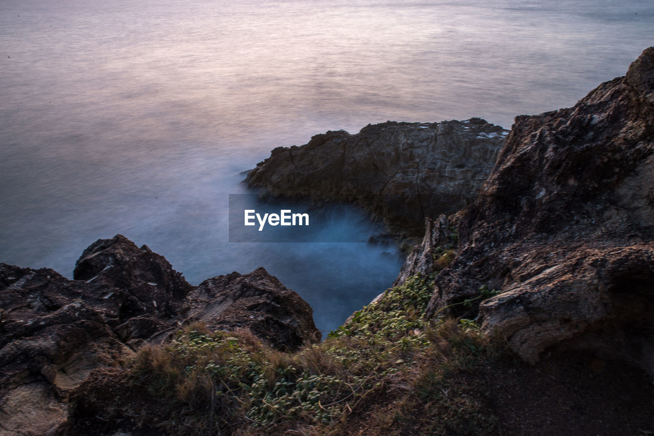 High angle view of rock formations at seaside