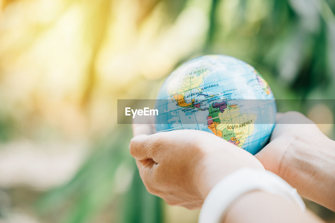 cropped hand of woman holding crystal ball