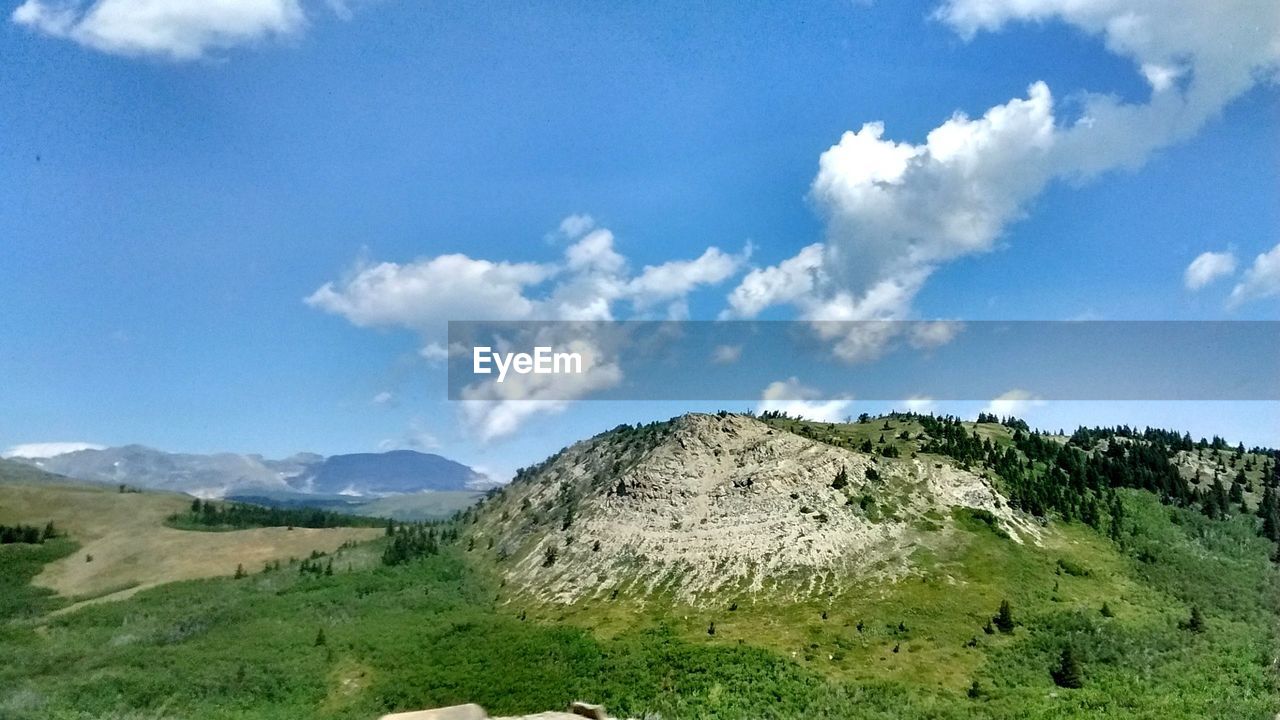 SCENIC VIEW OF MOUNTAINS AGAINST BLUE SKY