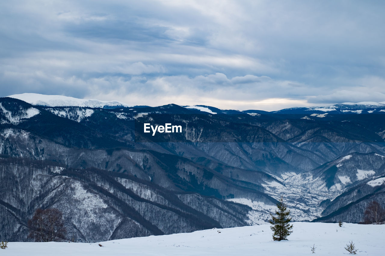 Scenic view of snowcapped mountains against sky