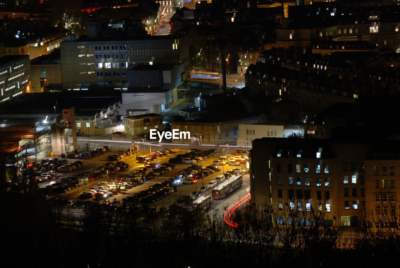 HIGH ANGLE VIEW OF ILLUMINATED BUILDINGS IN CITY