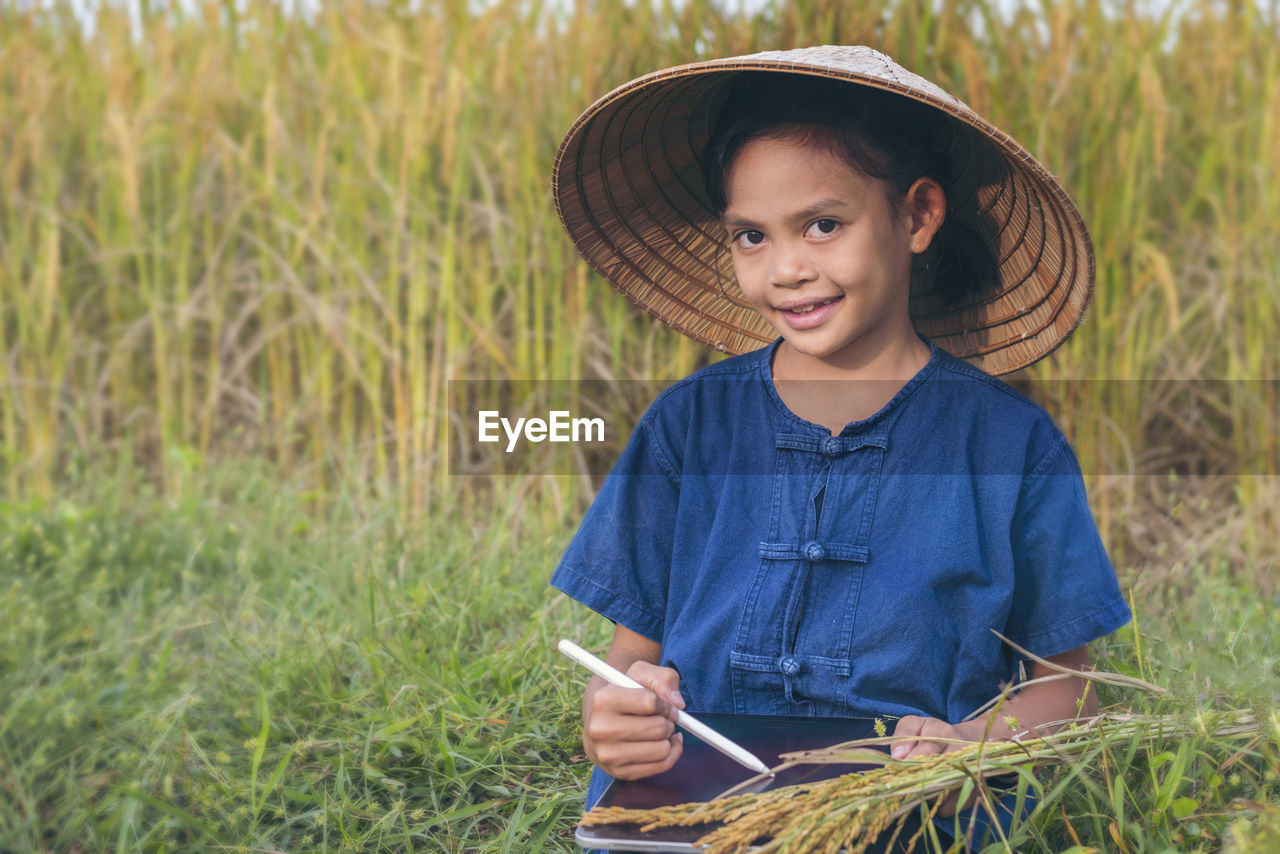 Portrait of smiling girl working on digital tablet