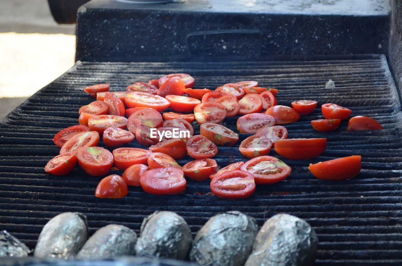 HIGH ANGLE VIEW OF RED CHILI PEPPERS ON GRILL