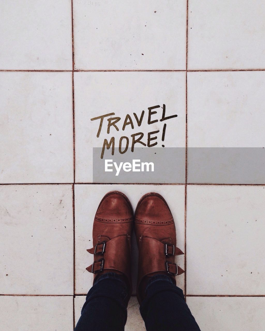 Low section of woman by text on tiled floor