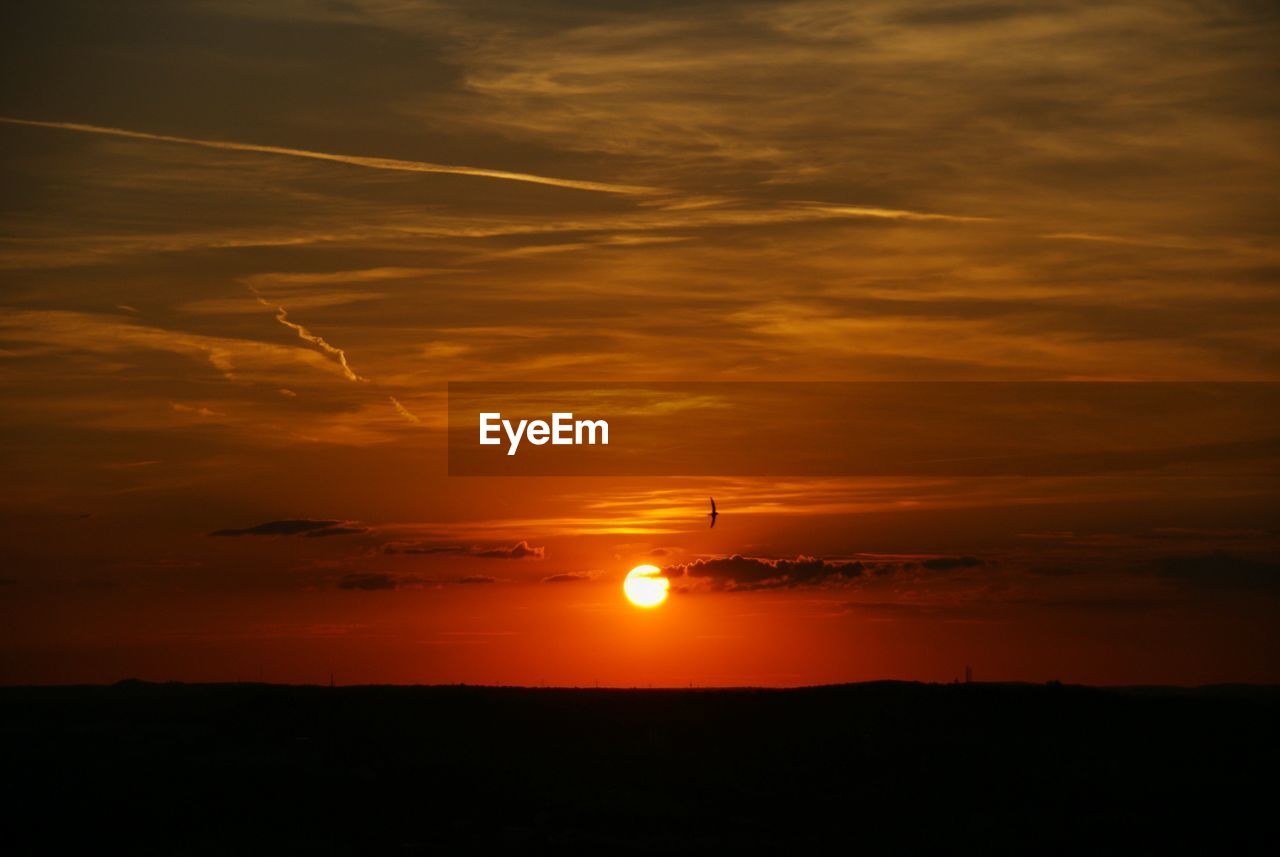 Scenic view of dramatic sky during sunset