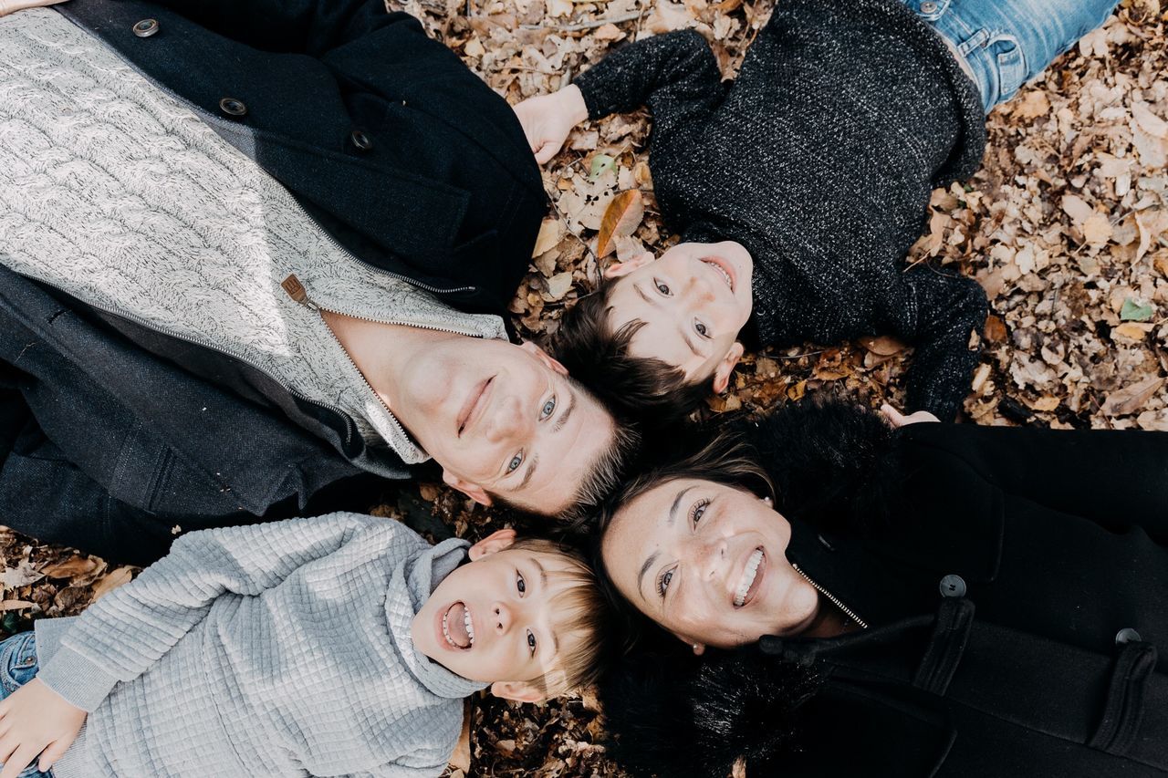 HIGH ANGLE VIEW PORTRAIT OF HAPPY GIRL WITH PEOPLE ON FLOOR