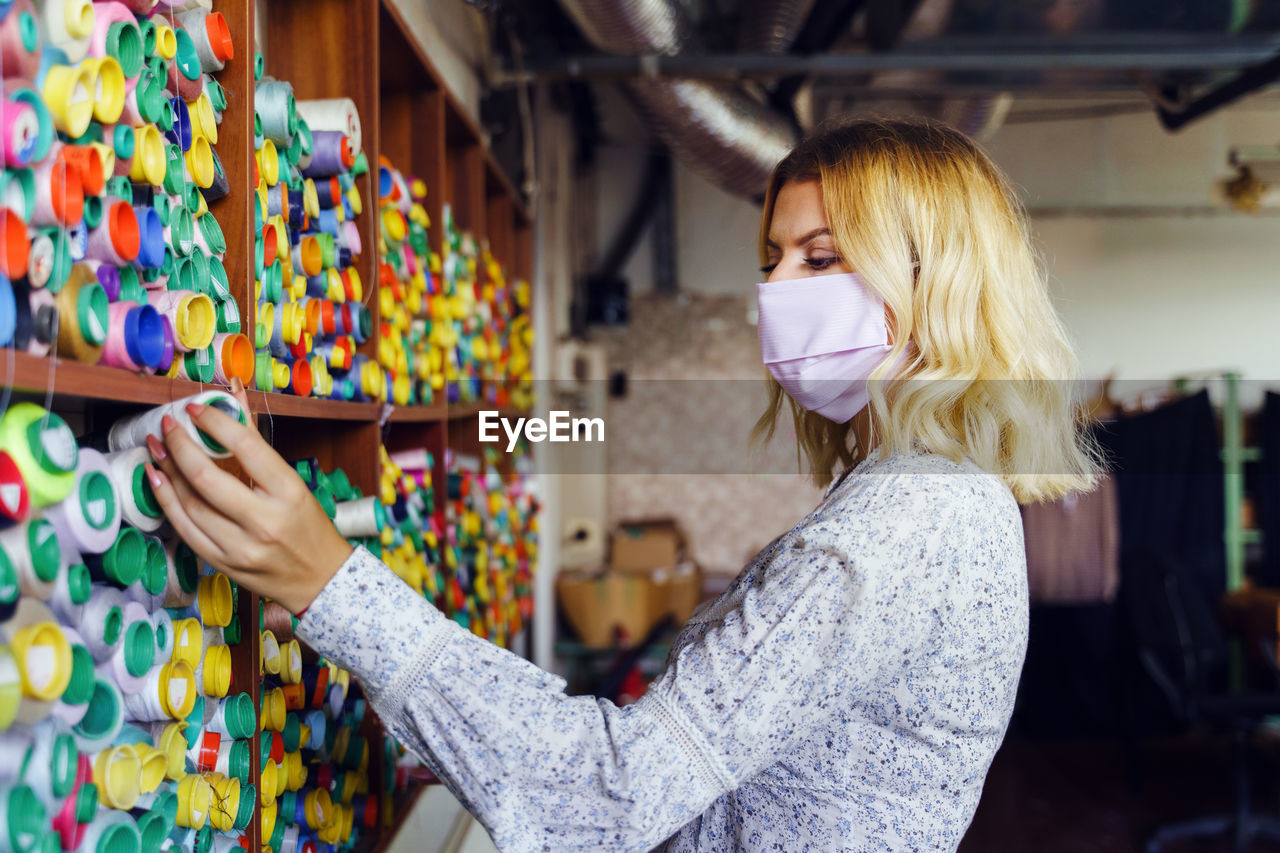 Woman standing in multi colored store