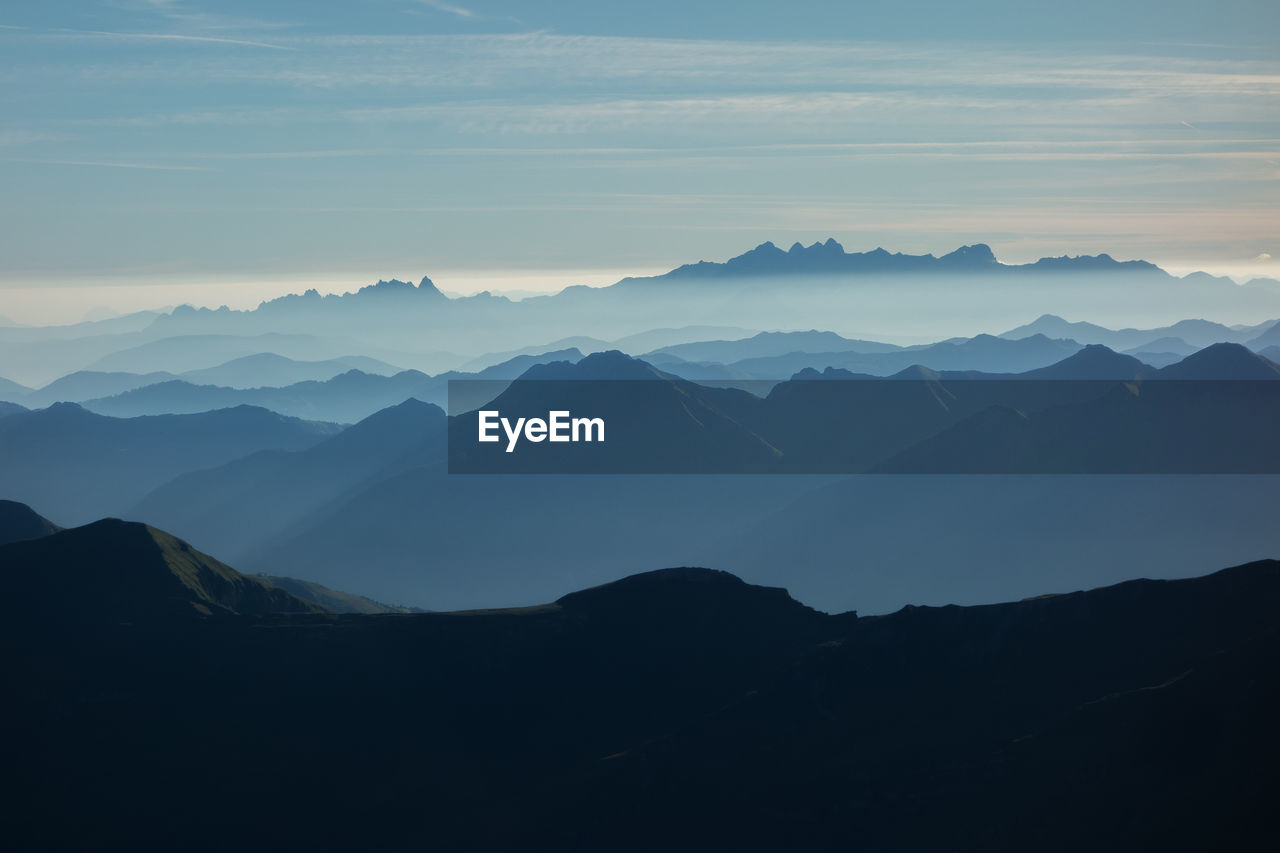 Scenic view of mountains against sky during sunset