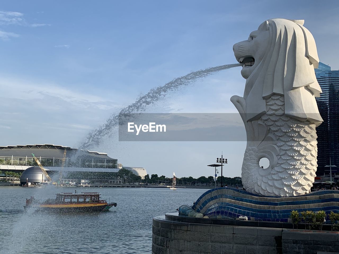 STATUE WITH FOUNTAIN IN BACKGROUND