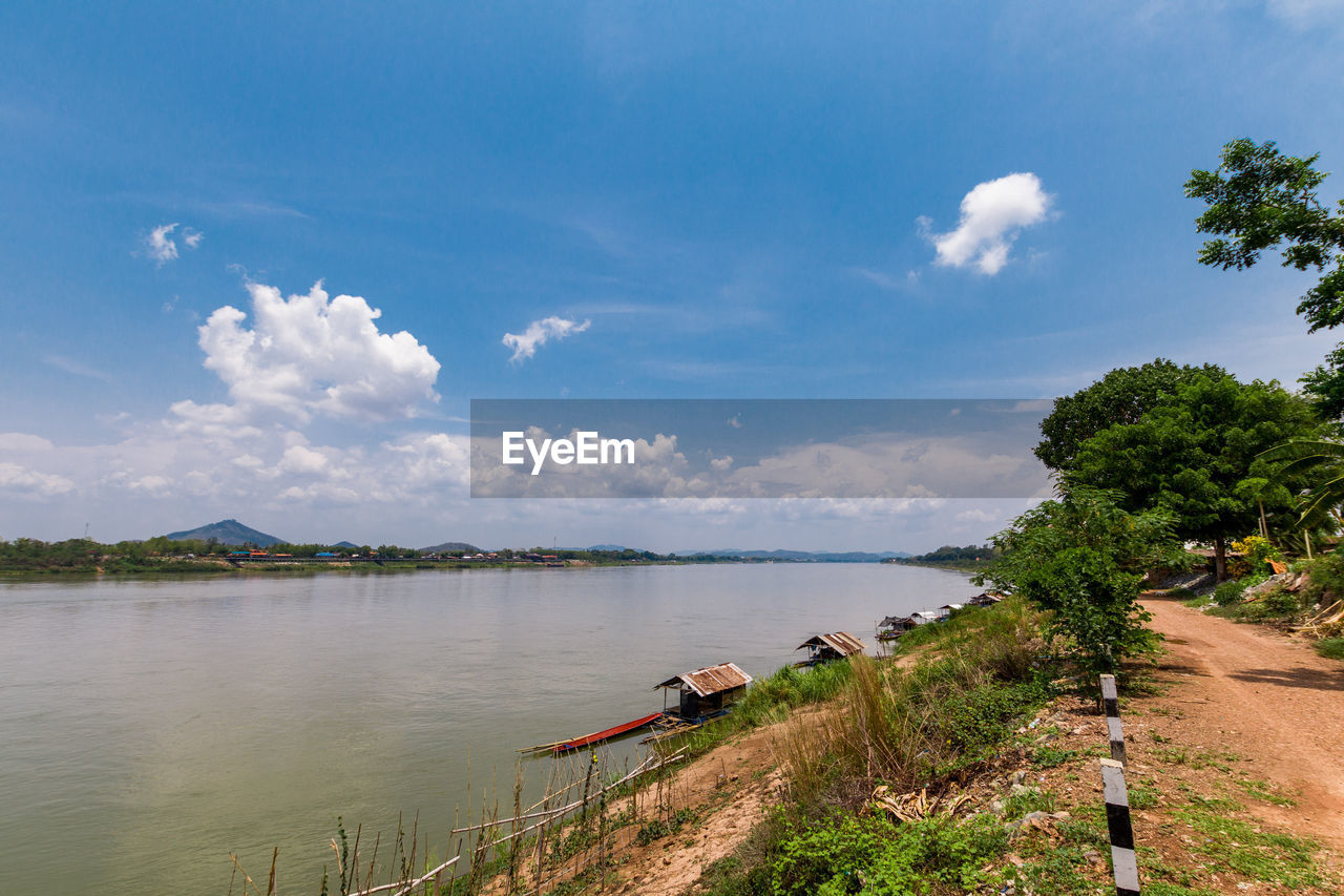 SCENIC VIEW OF RIVER BY TREES AGAINST BLUE SKY