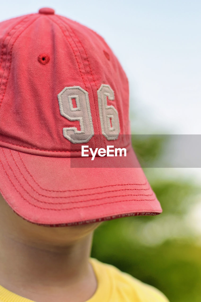 Close-up of boy with cap on face