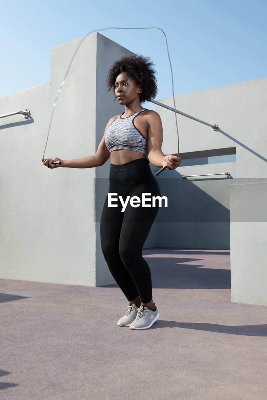 African american female athlete jumping with rope