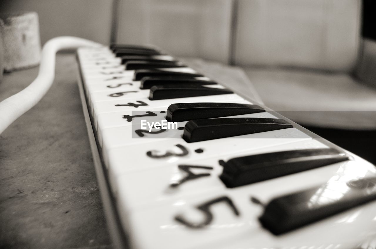 CLOSE-UP OF PIANO KEYS ON TABLE IN ROOM