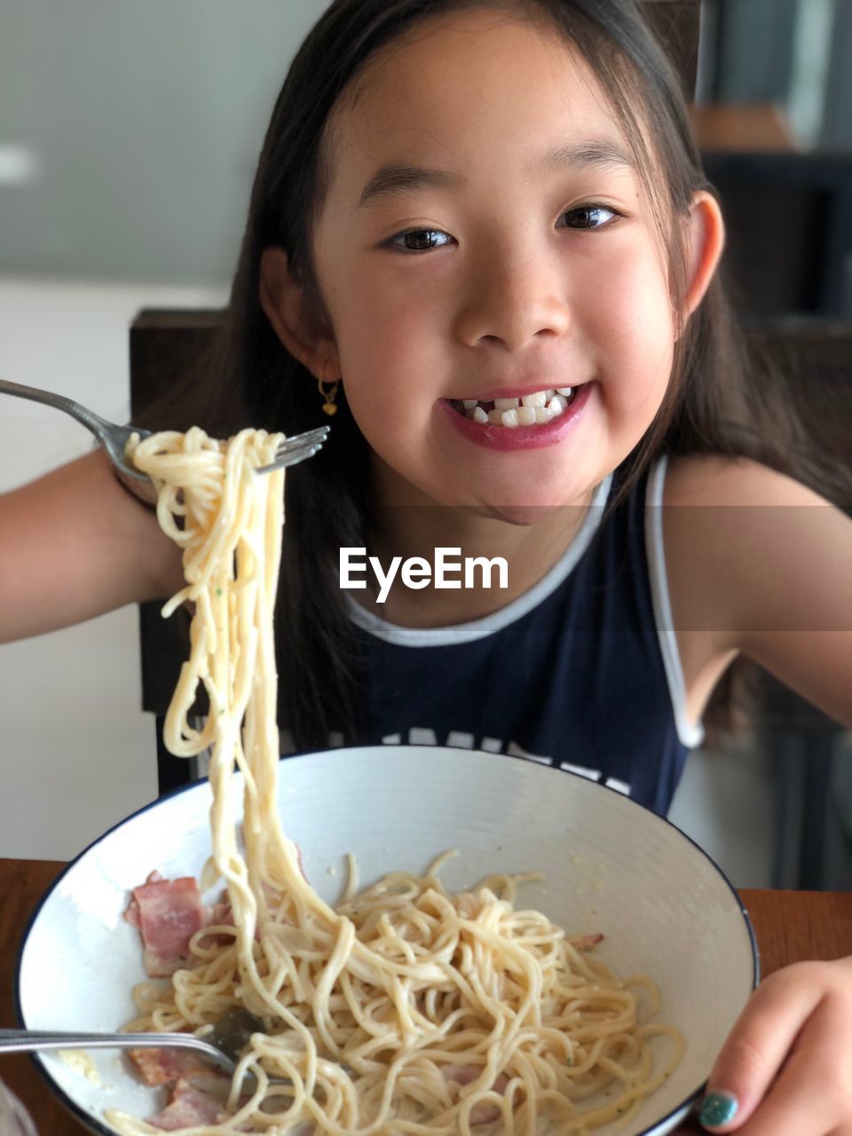 Portrait of girl having noodles