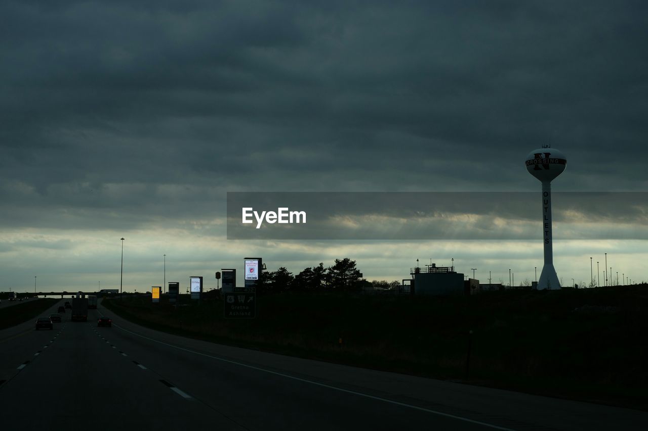 ROAD PASSING THROUGH CLOUDY SKY