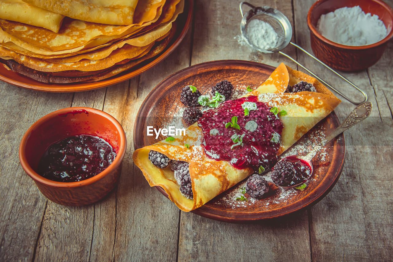 food and drink, food, fast food, dish, freshness, healthy eating, fruit, high angle view, produce, no people, meal, wood, breakfast, plate, wellbeing, table, plant, sweet food, indoors, bowl, baked, still life, cuisine, directly above, bread