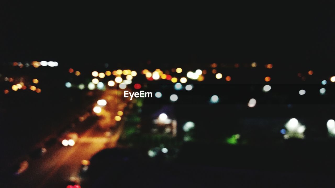 DEFOCUSED LIGHTS IN CITY AT NIGHT