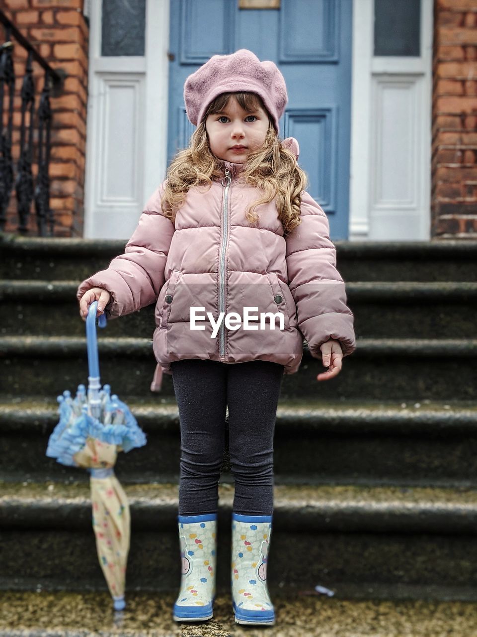 Full length of girl standing in front of the house