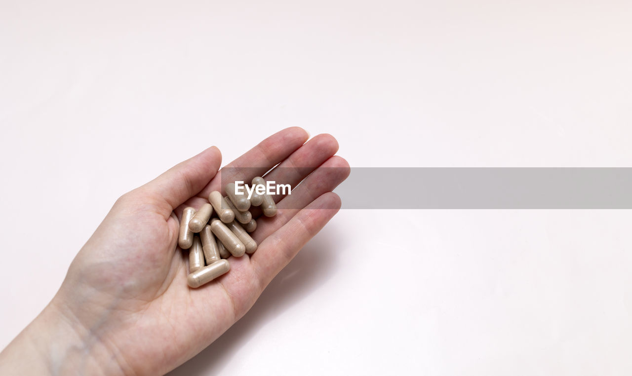 cropped hand of person gesturing over white background
