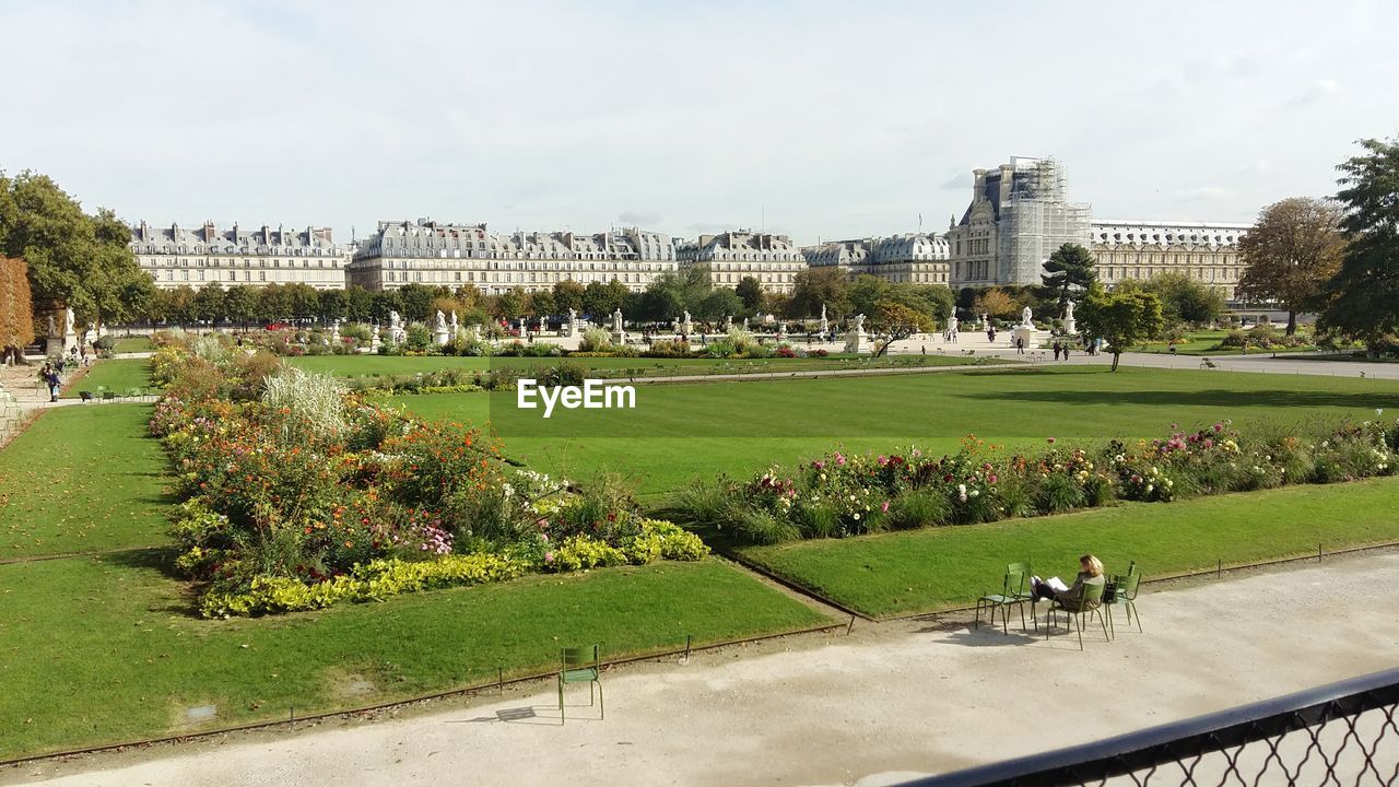 Park by city against sky