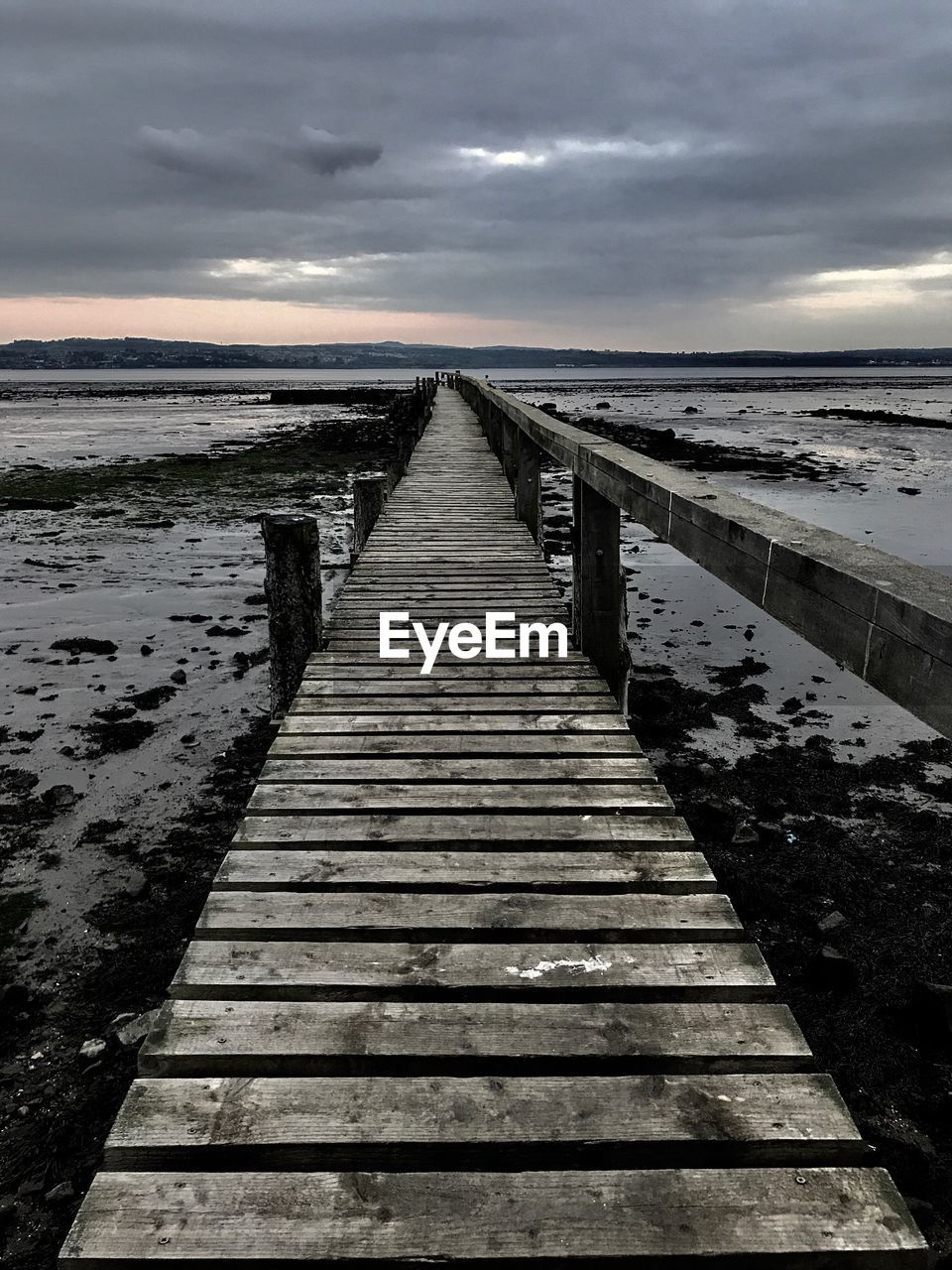 PIER AMIDST SEA AGAINST SKY