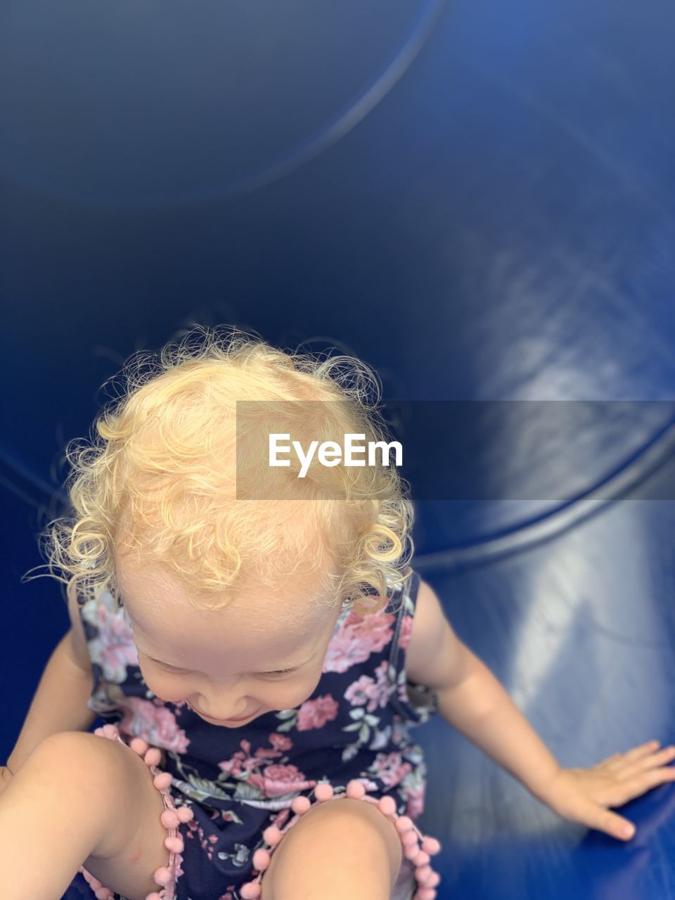 HIGH ANGLE VIEW OF CUTE BABY GIRL IN BEDROOM