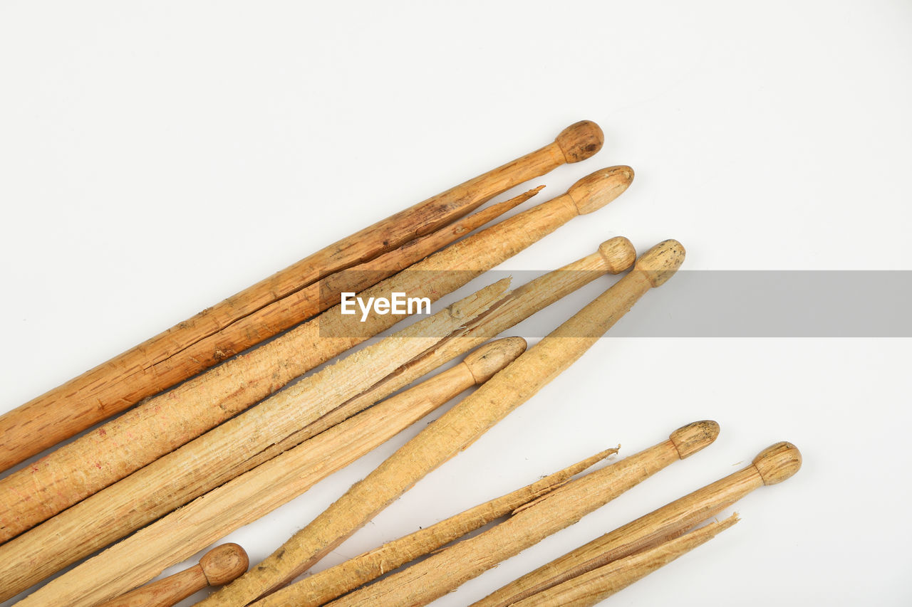 Close-up of wooden sticks over white background