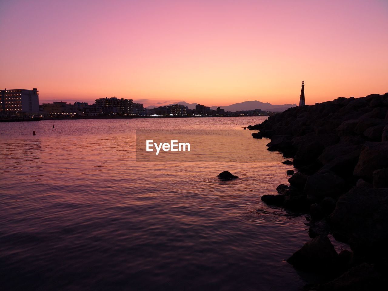 Scenic view of sea against orange sky