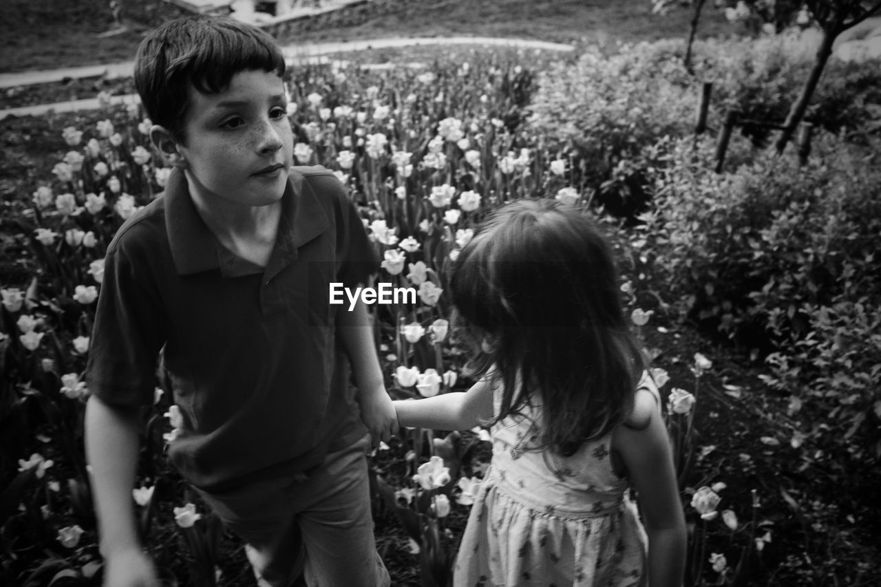 Siblings standing at park