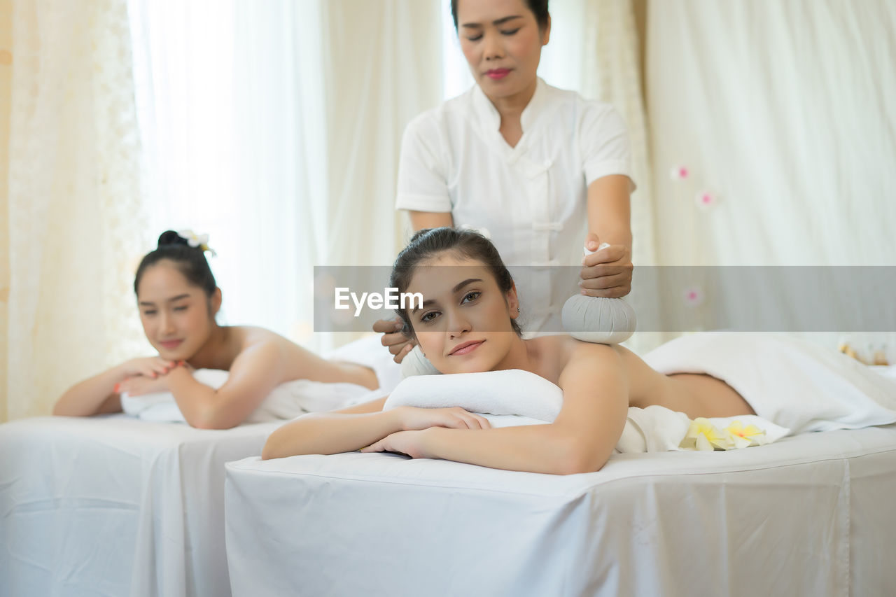 Young woman receiving massage in spa
