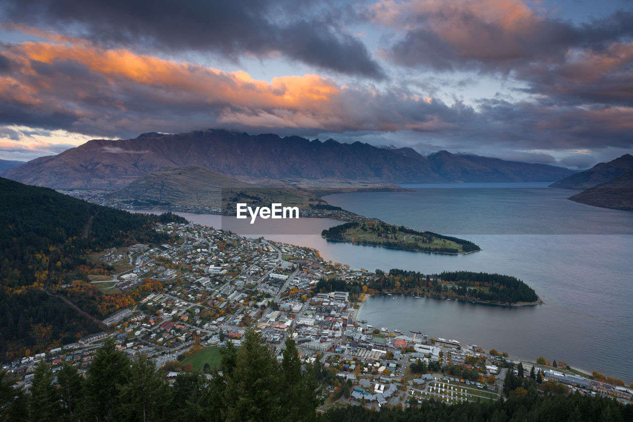 View of cityscape against cloudy sky